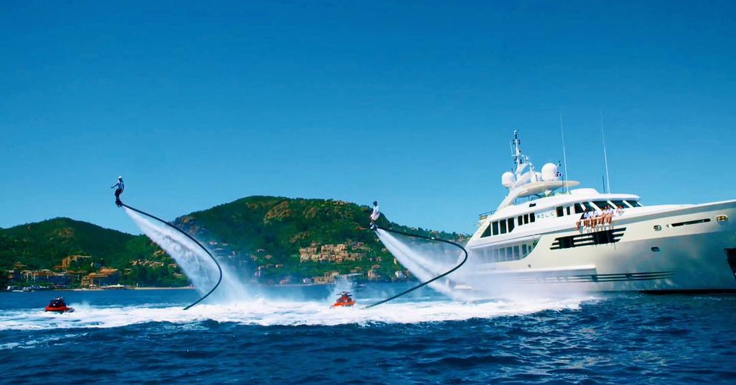 luxury yacht with jetpacks alongside