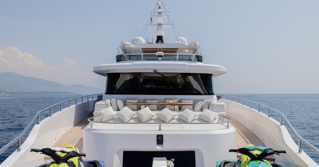 Overview of the sun pad and two Jet Skis sitting on deck onboard charter yacht OPTIMISM