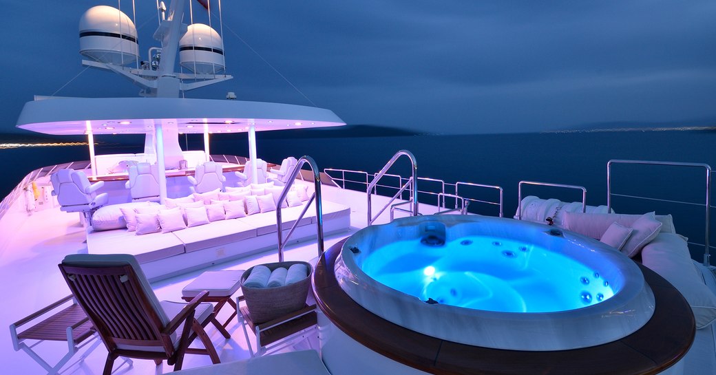 Charter yacht AZZURRA II sundeck, with illuminated jacuzzi pool and seating areas