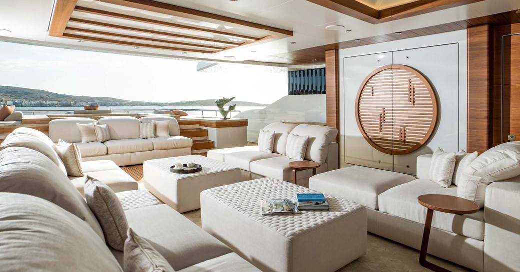 Interior lounge area with white seating onboard charter yacht LIFE SAGA