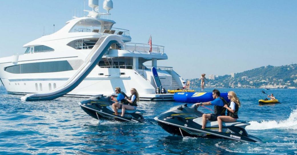 superyacht Big Sky at anchor in the Bahamas as charter guests take to the jet skis