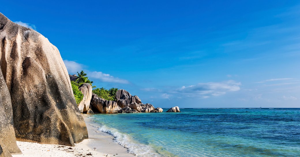 beach in the indian ocean, white sand beaches and large rocks