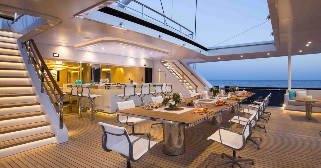 Dining table and bar area of luxury yacht AQUIJO