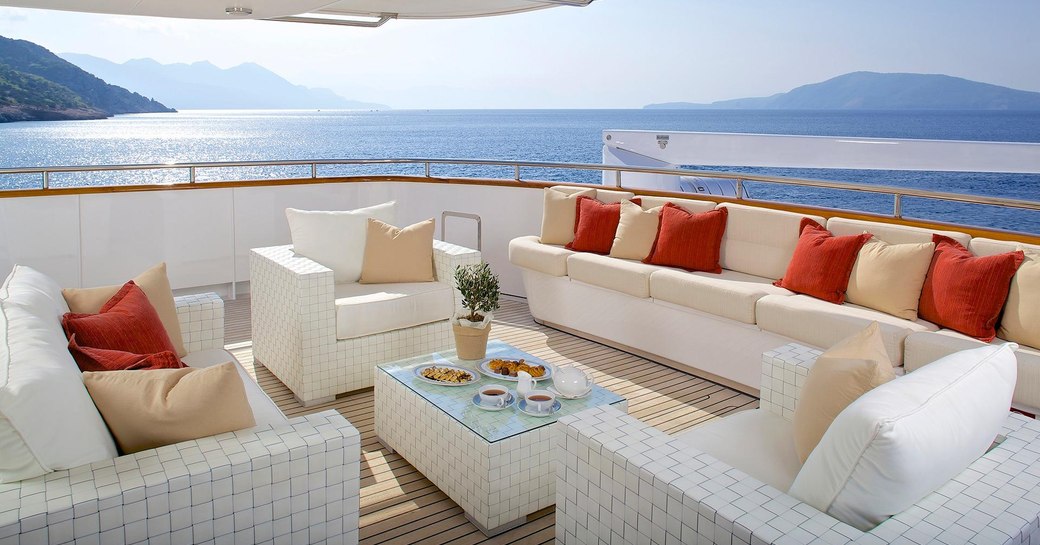 seating area on superyacht idylle, sofa seating with lovely cushions and glass coffee table