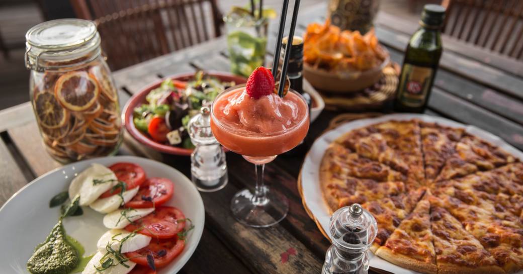 Table of food, including pizza, salad and frozen cocktails served at Diablito in Yas Marina, Abu Dhabi 