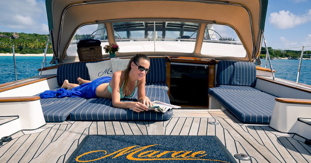 Guest enjoys a book whilst on her luxury charter vacation