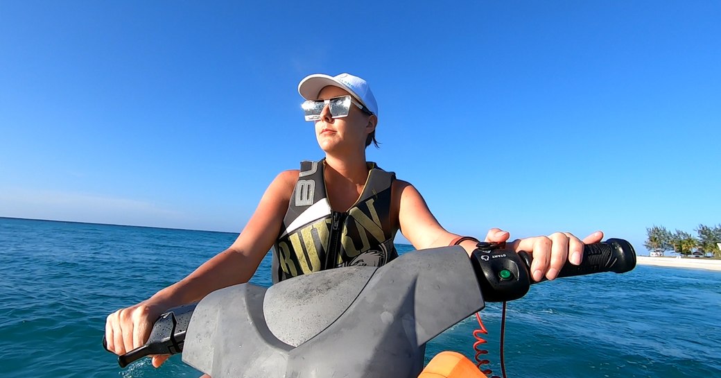 woman rides waverunners in the sea near thanda island