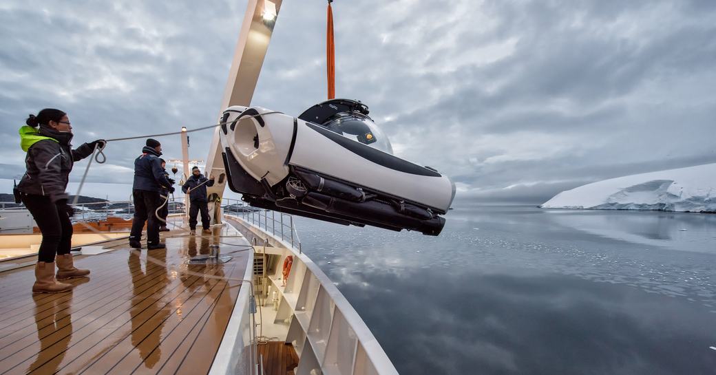 Charter yacht AQUA LARES water toy being launched by crew