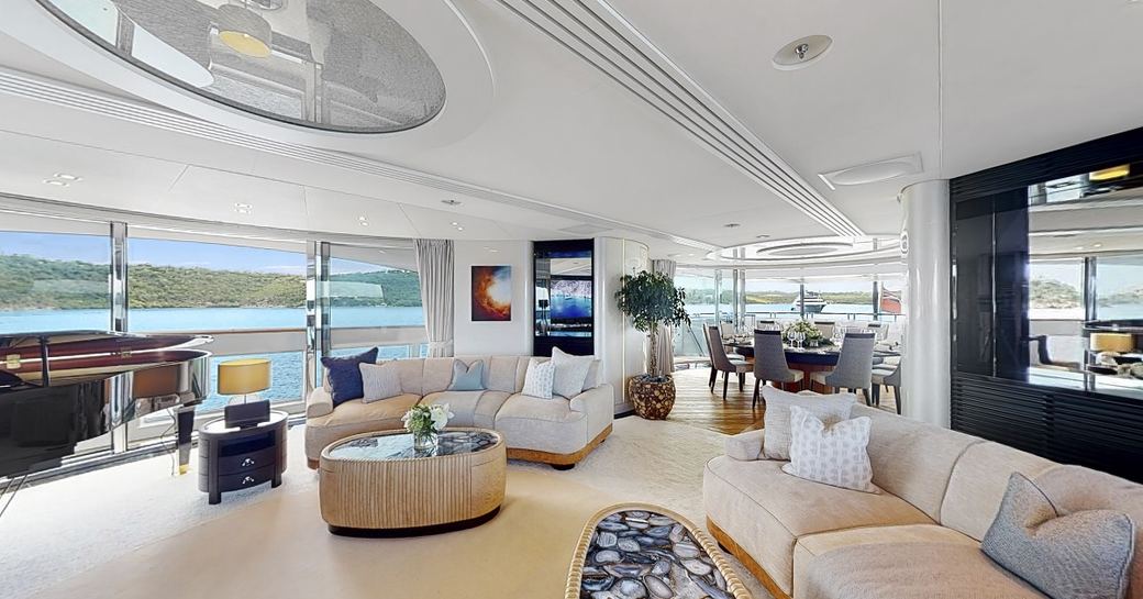 Main salon with plush lounge area and lots of windows onboard superyacht charter AFTER YOU