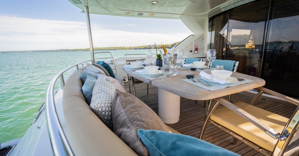 dining arrangement on the aft deck of luxury motor yacht chess