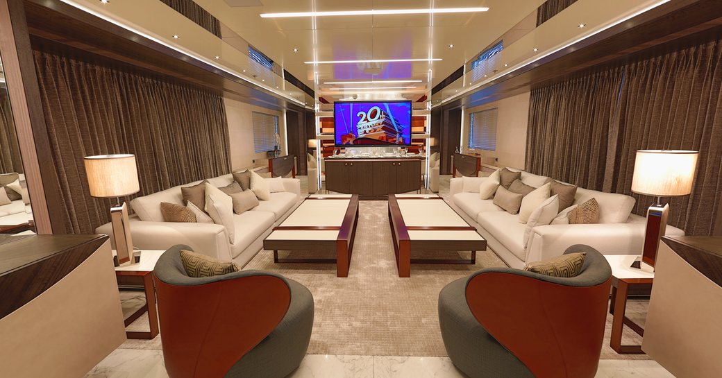 Main salon lounge area with cream sofas onboard superyacht charter STARBURST III