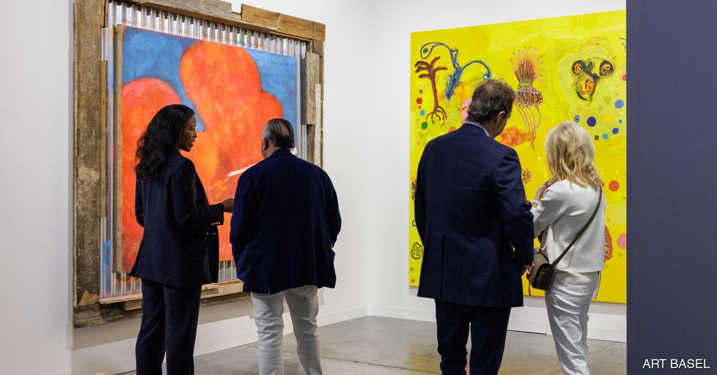 Art Basel Miami visitors viewing paintings