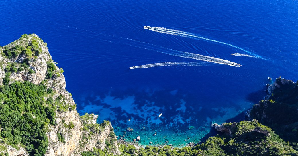 An aerial view of a Greek bay populated by charter yachts