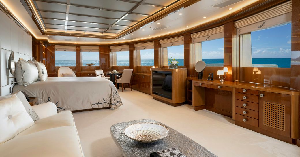 Master cabin with central berth and multiple windows onboard charter yacht ALFA NERO