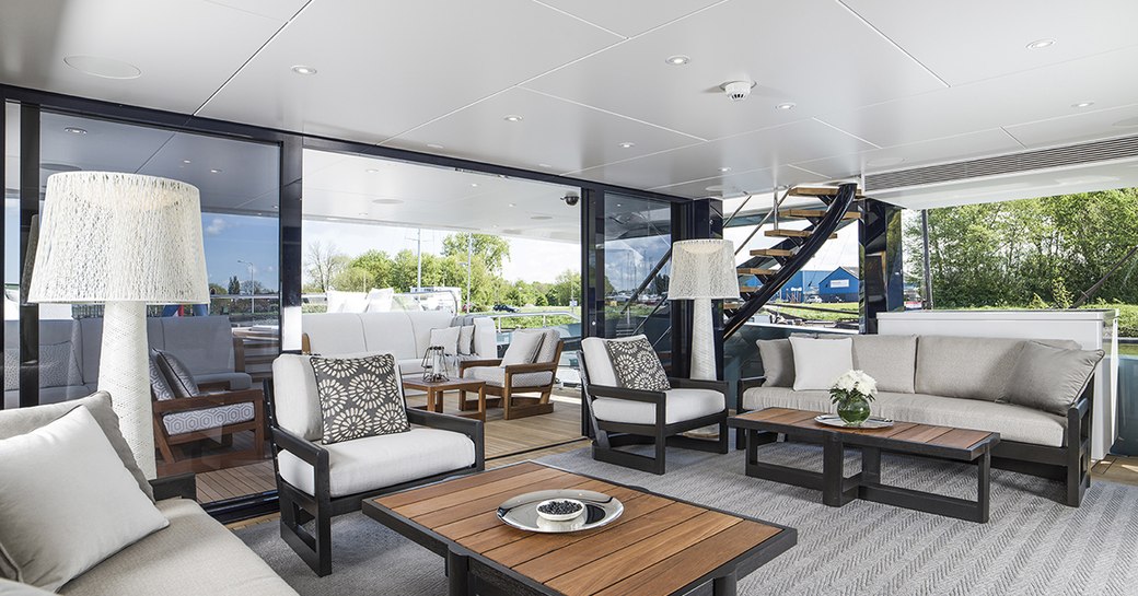 Winter garden with aft deck outdoor area aboard charter yacht Irisha