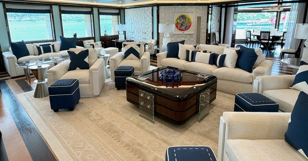 Interior lounge area with many surrounding windows and plush seating onboard superyacht charter ALFA NERO