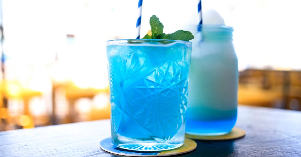 heavenly blue hued cocktail with fluffy cream on the table of a yacht club in St. Lucia 