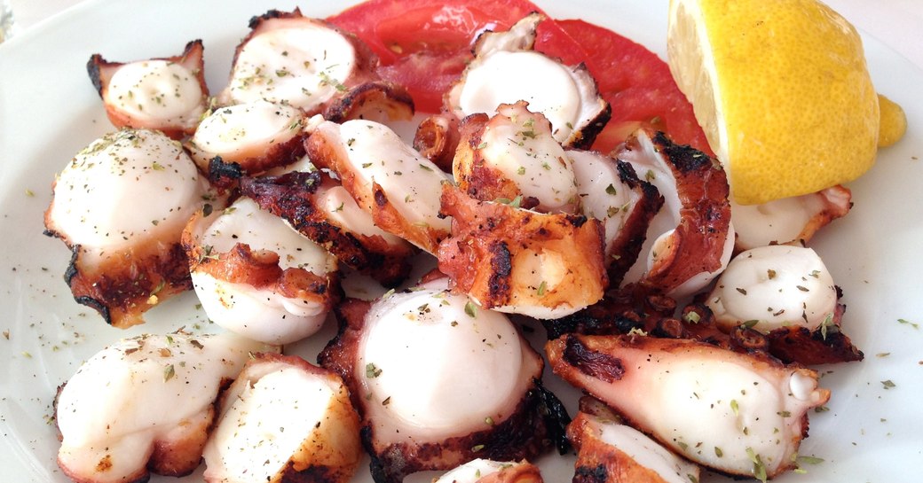 octopus served with lemon, salt and pepper in Greece