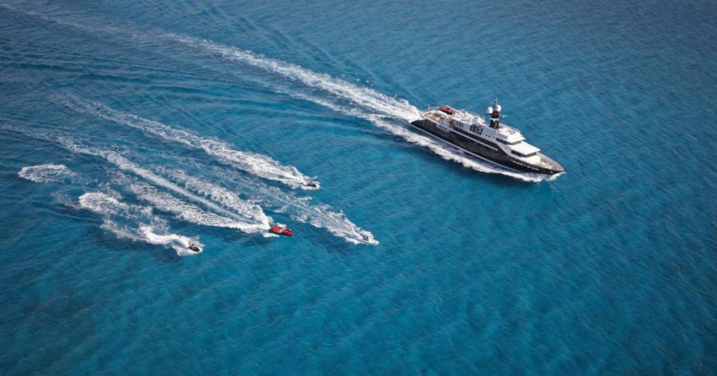 Superyacht HIGHLANDER with her attendant tenders