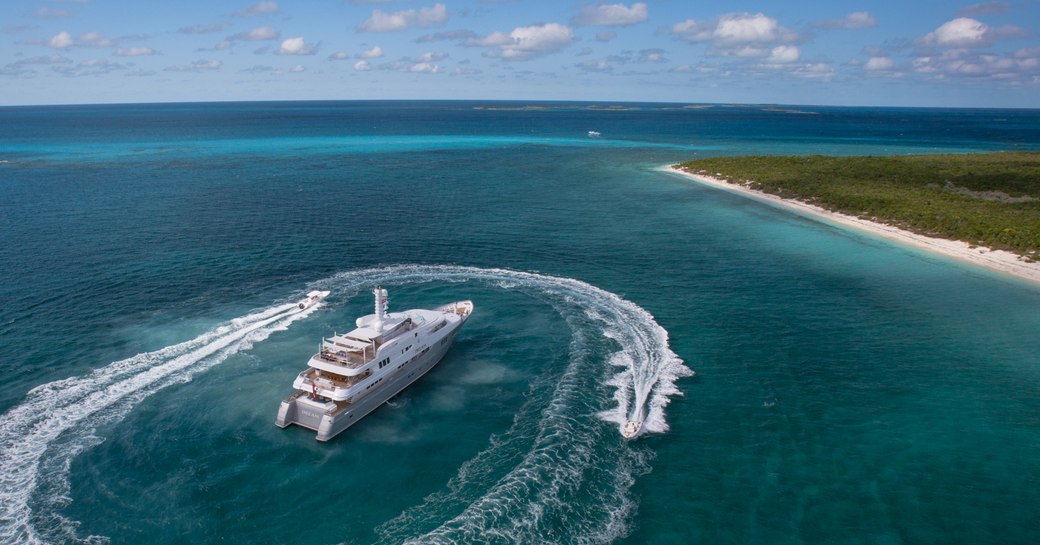 luxury superyacht in the caribbean with jet-skis alongside