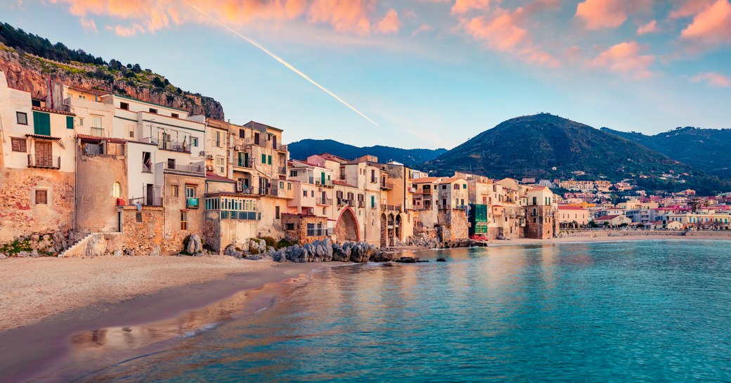 Attractive evening cityscape of Cefalu town. Amazing sunset on Mediterranean sea, Sicily, Italy, Europe.