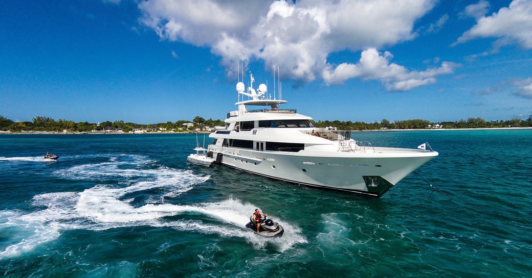 Superyacht W underway with a jet ski running along her starbaord side