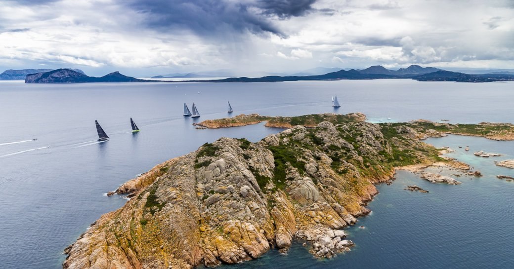 Aerial shot of superyachts on the water around Porto Cervo for Loro Piana Regatta