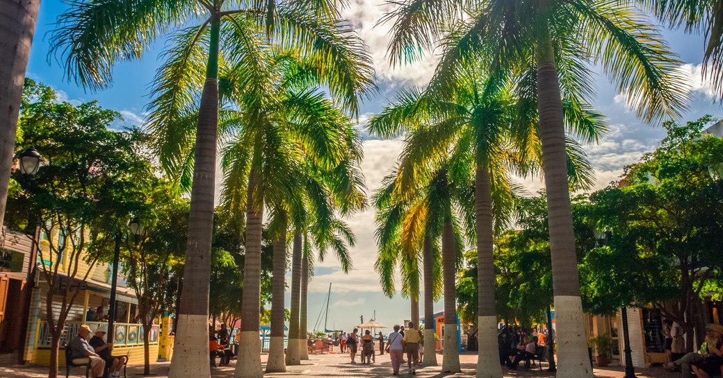 tourist walking through a bright and sunny broad walk on a luxury yacht charter vacation to Saint Martin