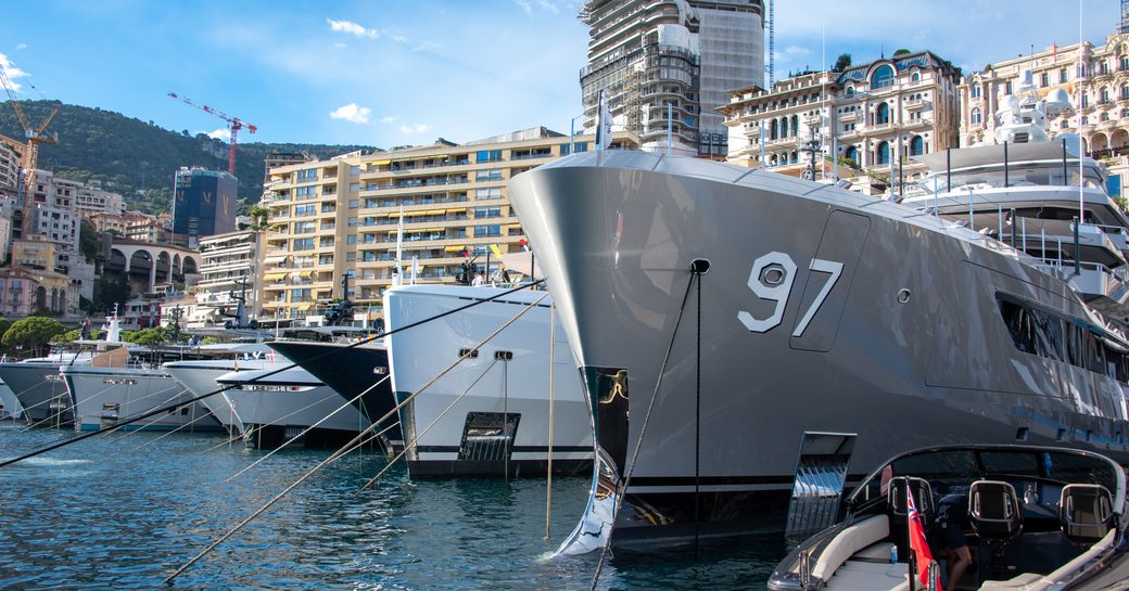 Superyacht bows berthed in line at Monaco Yacht Show
