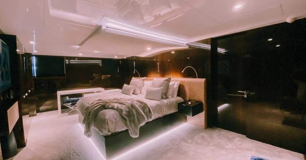 Large cabin on superyacht OCULUS with hushed lighting from under bed