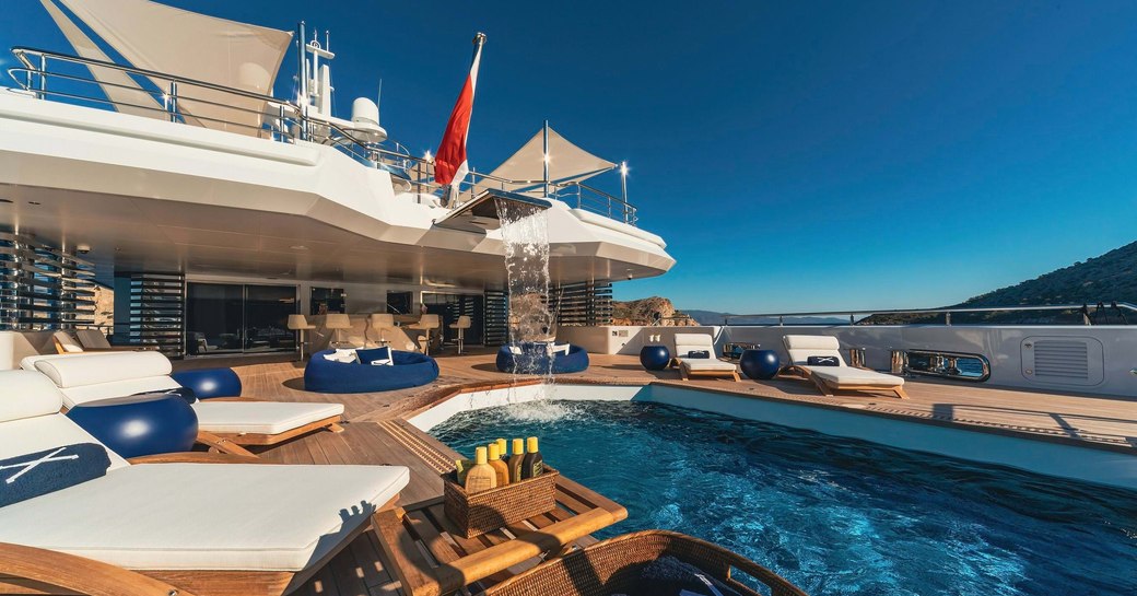 Overview of the swimming pool and sun loungers onboard charter yacht PROJECT X