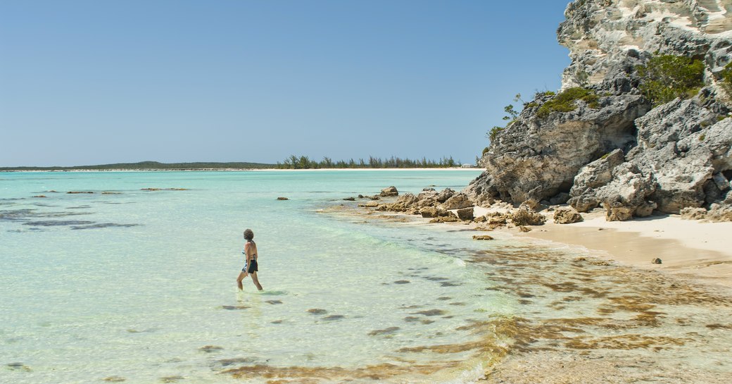 Man wades in shallow water on Cat Island