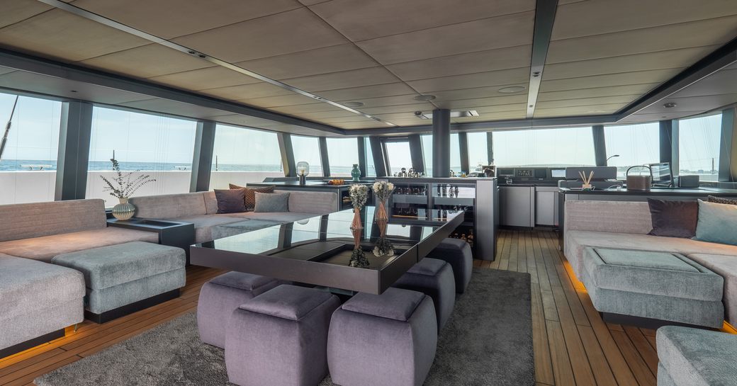 Charter yacht SHADES OF GREY interiors with plush lounge and plenty of windows