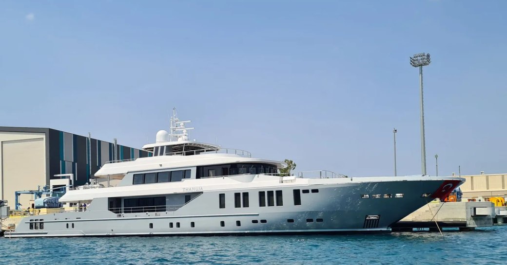 Sea level view of charter yacht THANUJA awaiting transportation outside construction shed