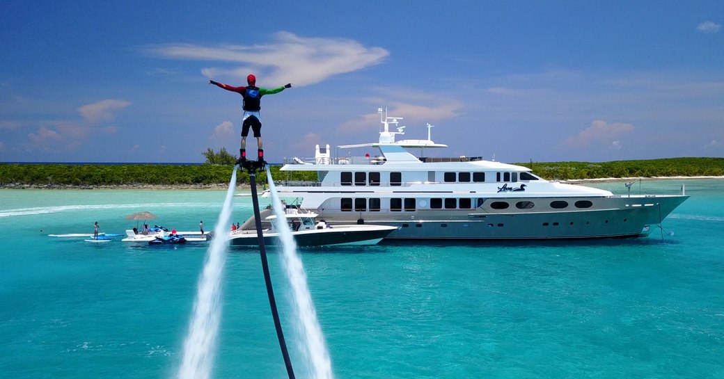 Man on water toy high above superyacht ZEAL