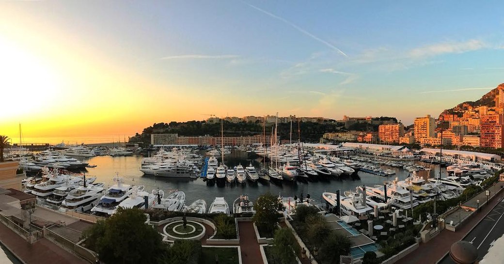 A collection of superyachts photographed at sunset during the Monaco Yacht Show 