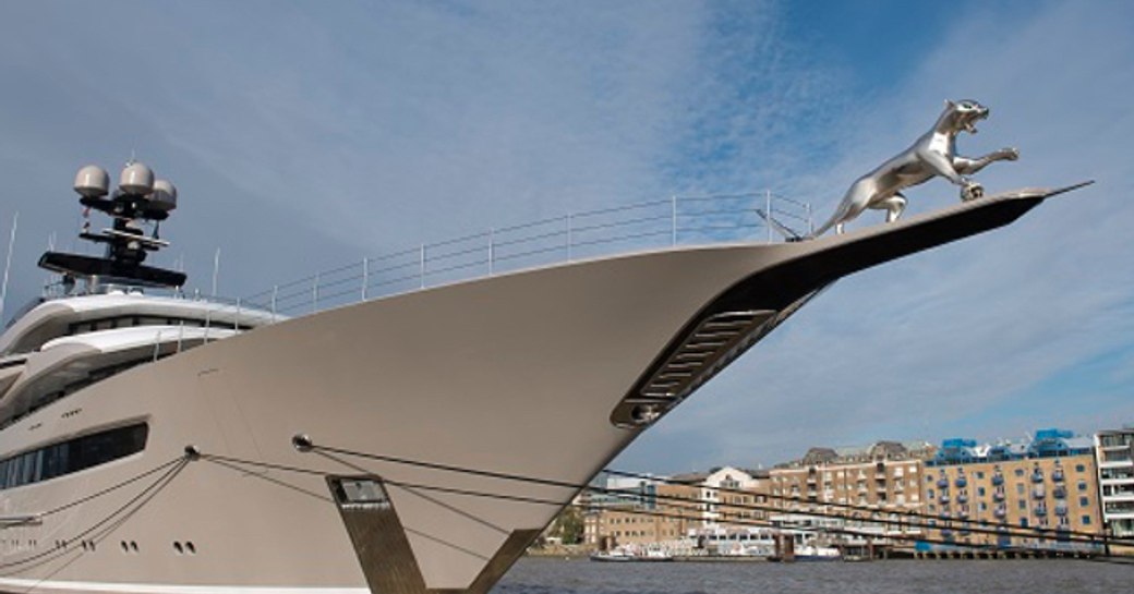 Ground level view looking up at the silver Jaguar attached to the bow on M/Y KISMET