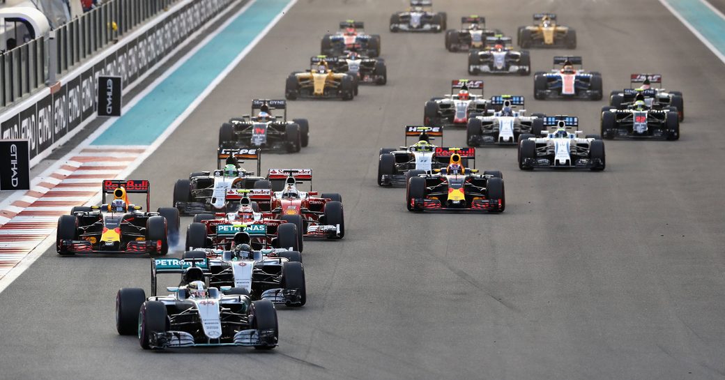 Front view of cars racing on the track of Yas Marina Circuit at the Abu Dhabi Grand Prix, beginning to turn a corner