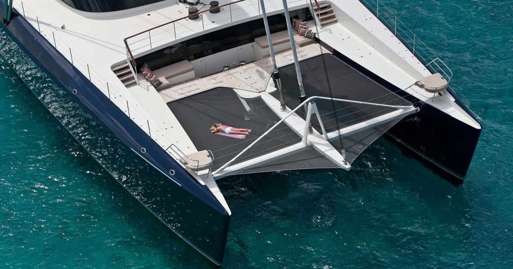 Overhead view of charter yacht HEMISPHERE with charter guest sunbathing