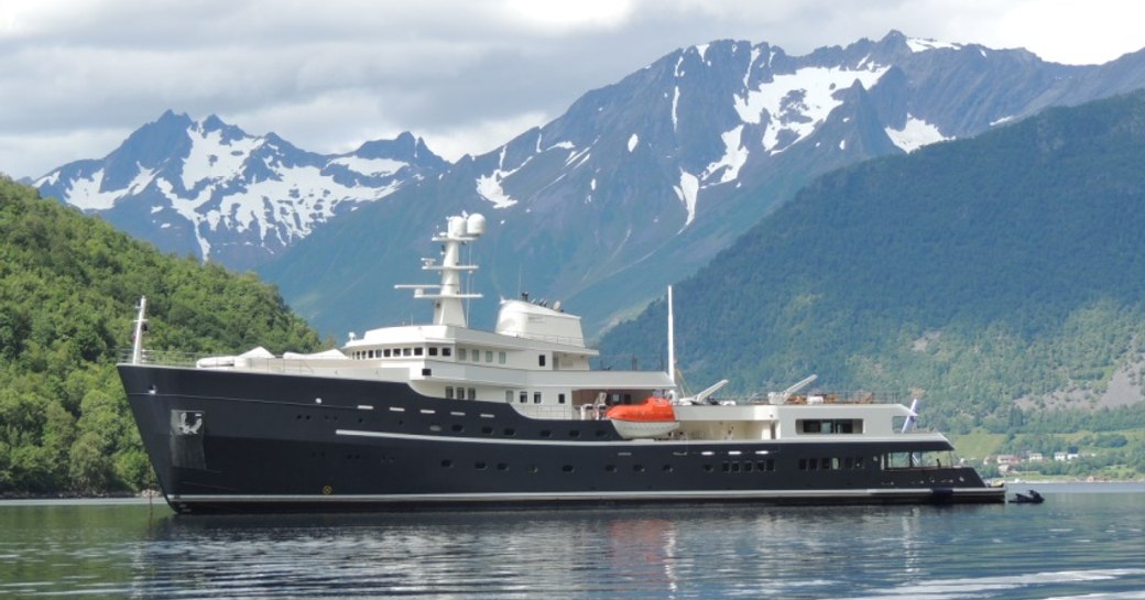 The iconic superyacht LEGEND with snowy mountains in the background