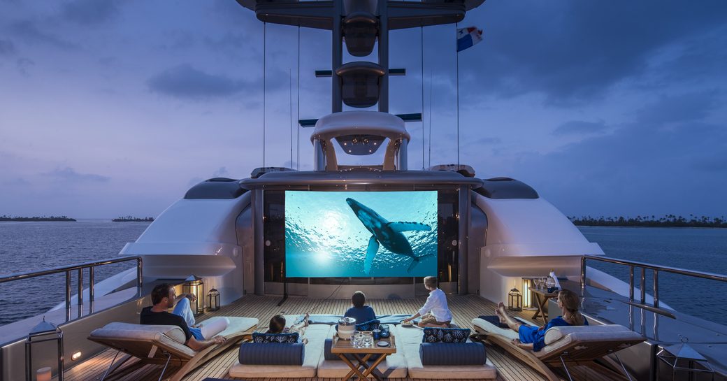 guests enjoying the cinema one their superyachts flybridge