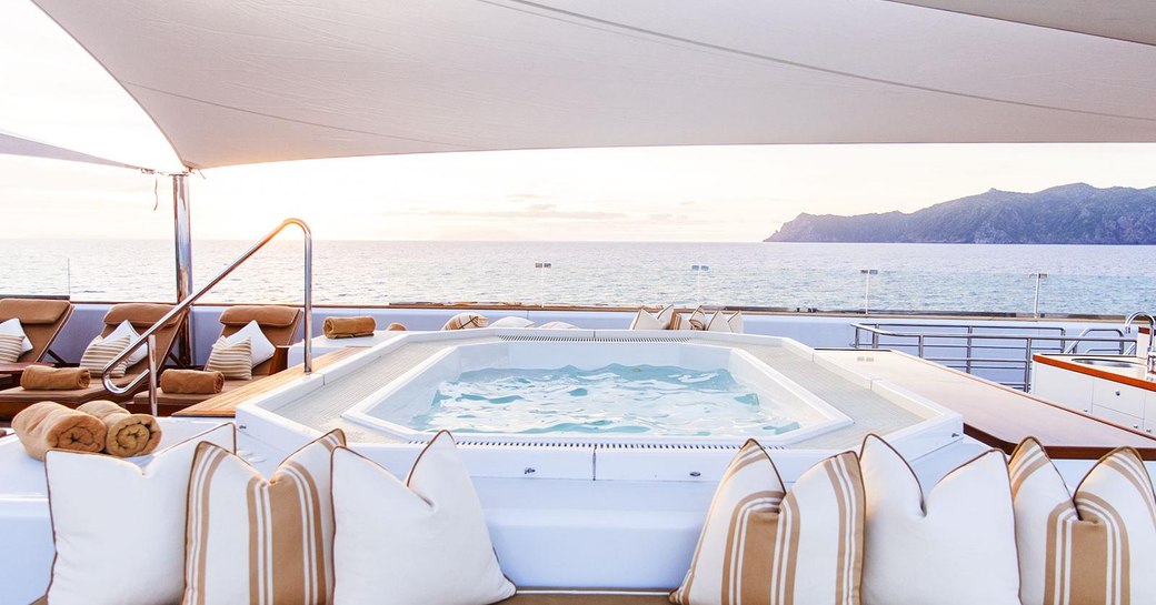 Sun deck jacuzzi with sofa seating on superyacht Suri