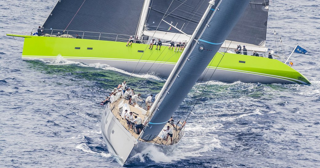 Two sailing yachts on the water in Sardinia, undertaking Loro Piana Superyacht Regatta