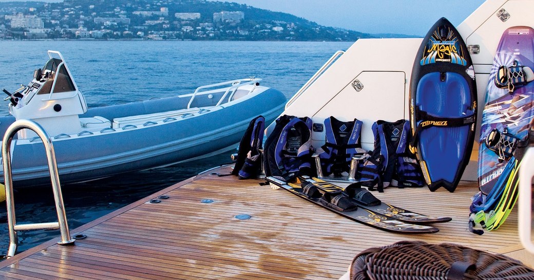 water toys laid out on the swim platform of motor yacht One More Toy 