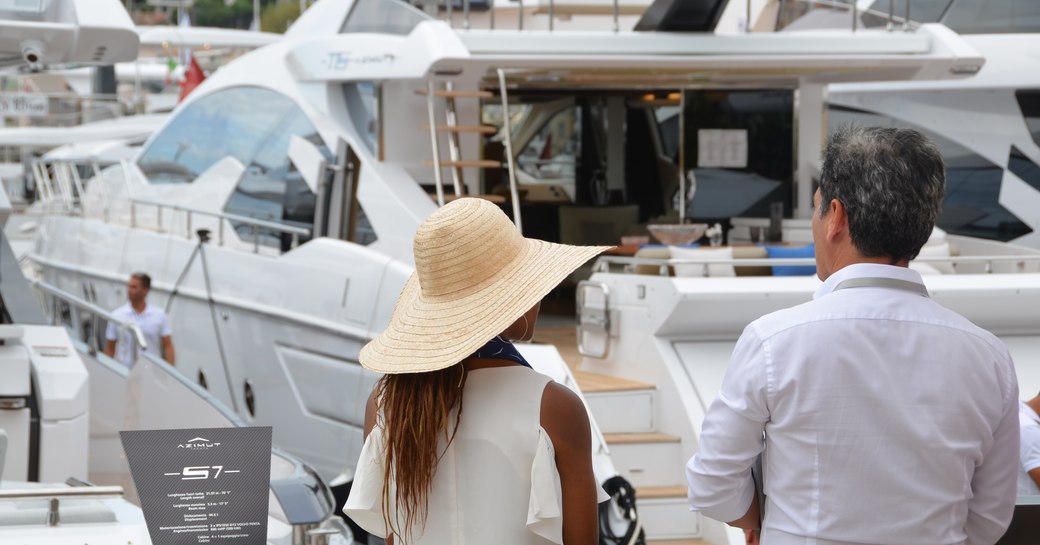 Woman stands with yacht broker at Cannes Yachting Festival