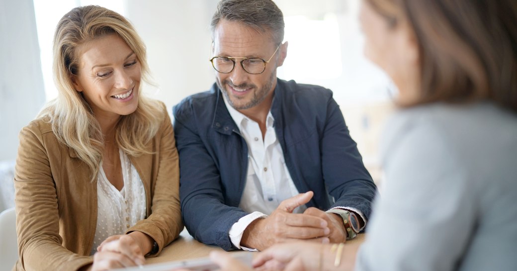 Professional woman giving advice to an attractive middle-aged couple