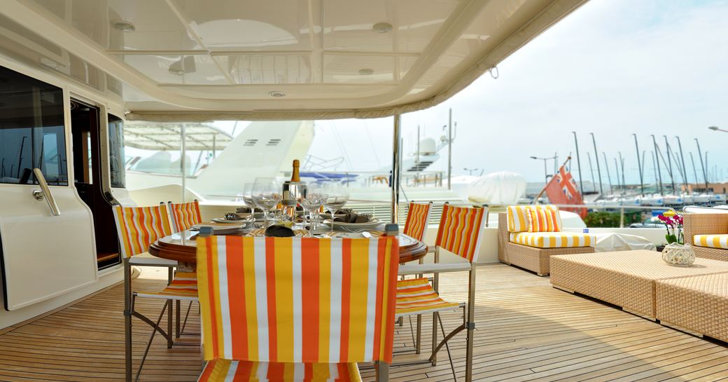 Aft deck alfresco dining set-up on deck of superyacht 