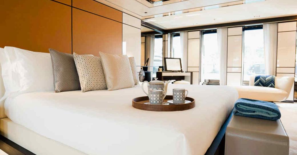 Master cabin onboard charter yacht RELIANCE, central berth and multiple windows aft