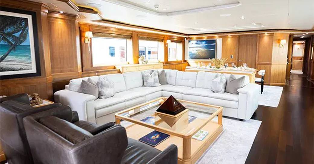 Interior lounge area with large sofas onboard charter yacht INVICTUS