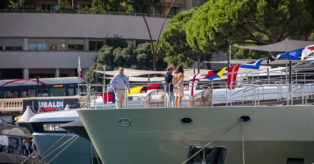 Visitors with masks view a yacht in-show at the MYS 2021